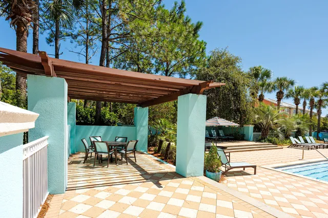a view of a swimming pool with sitting area and furniture
