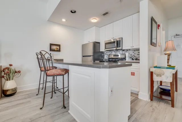 a kitchen with stainless steel appliances granite countertop a refrigerator and a stove top oven
