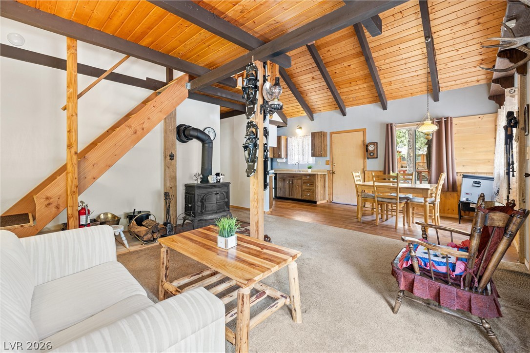 2146 Via Spes Nostra Street Mount Charleston, NV 89124 - Photo 15 of 33 A cozy, open-concept living space with rustic charm and high vaulted ceilings.
