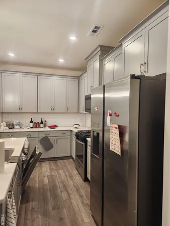 a kitchen with refrigerator and cabinets