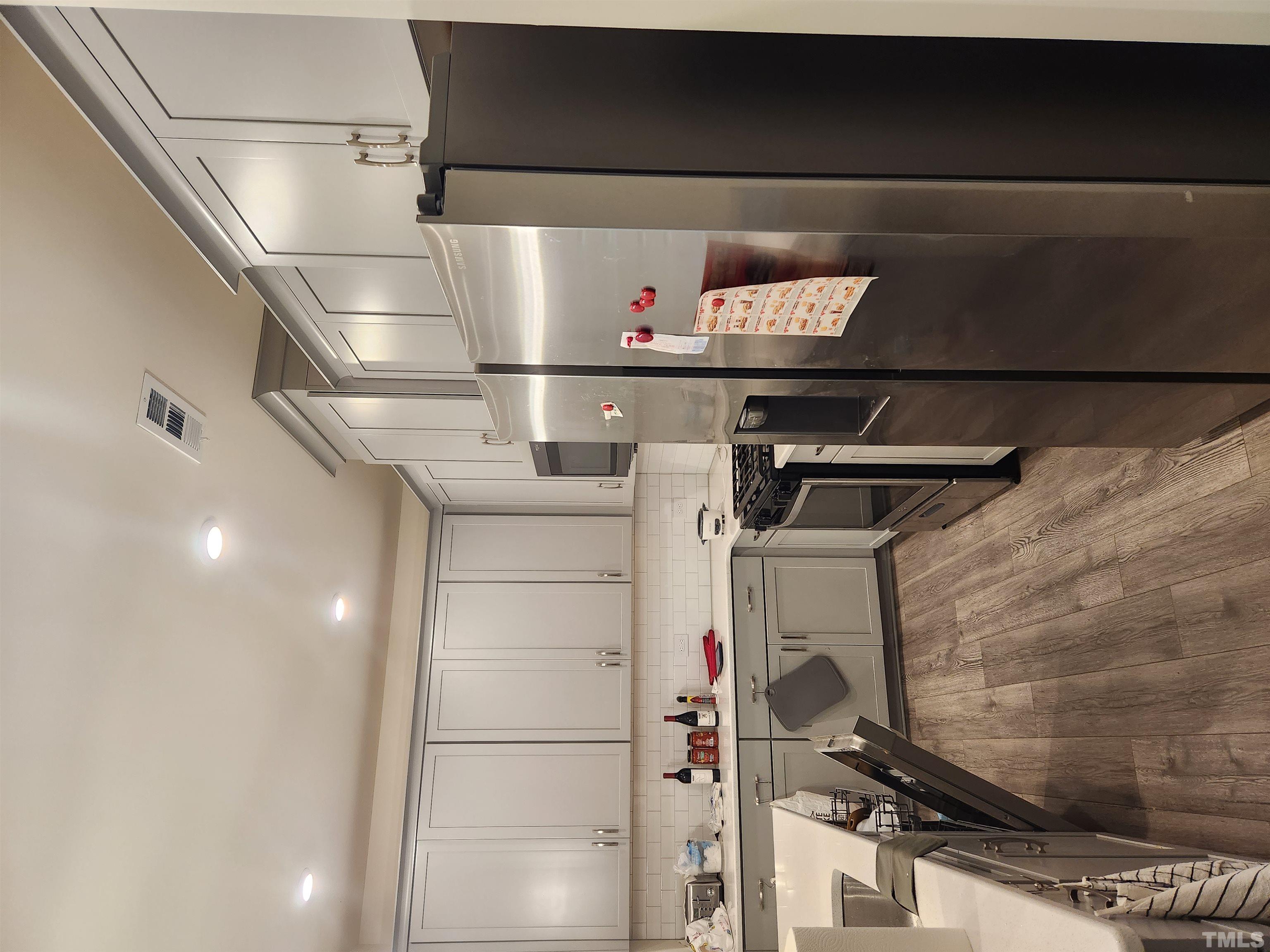 2093 Shaded Knoll Road Cary, NC 27519 - Photo 4 of 9 a kitchen with refrigerator and cabinets