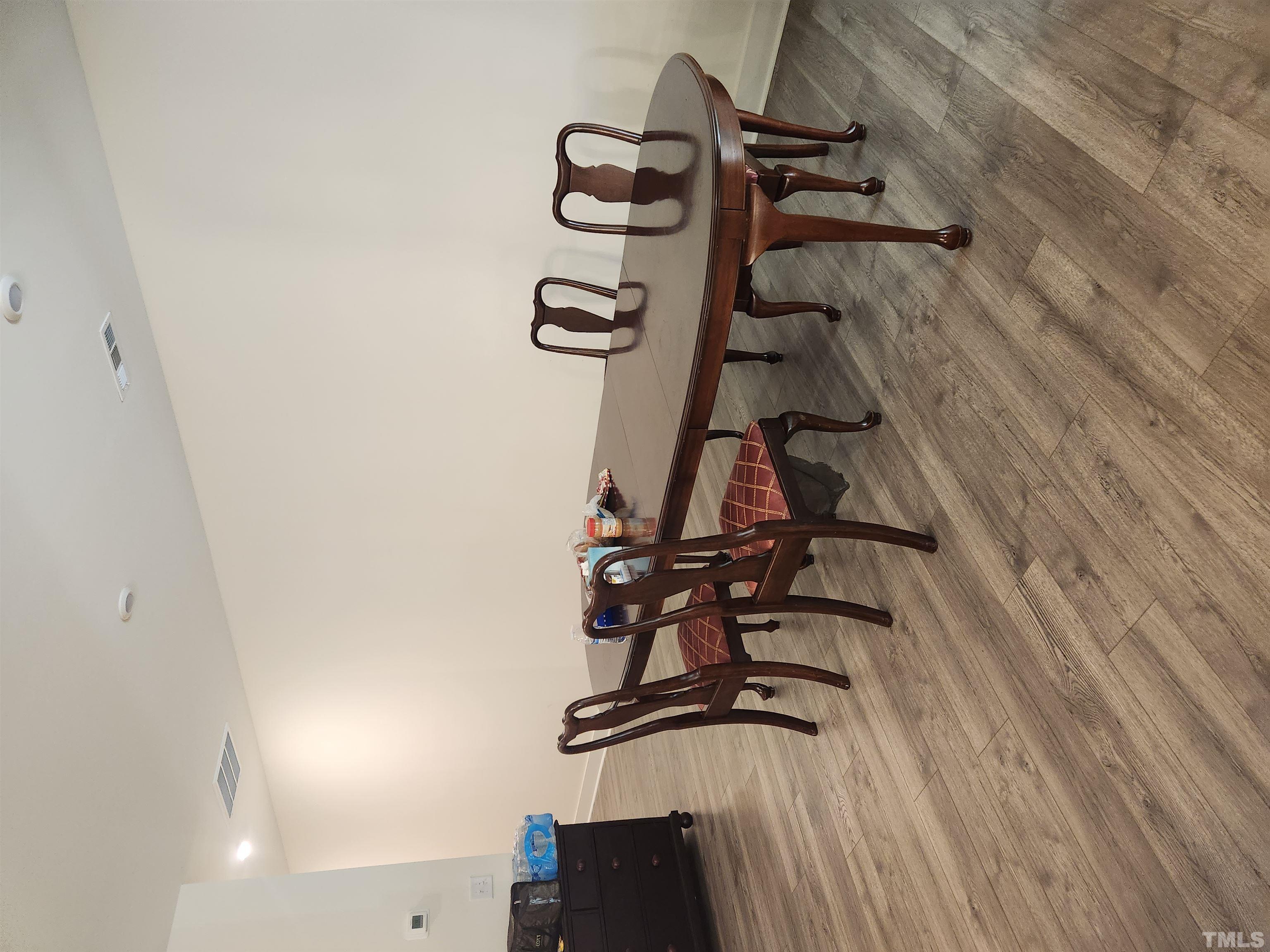 2093 Shaded Knoll Road Cary, NC 27519 - Photo 6 of 9 a view of a dining room with furniture and wooden floor