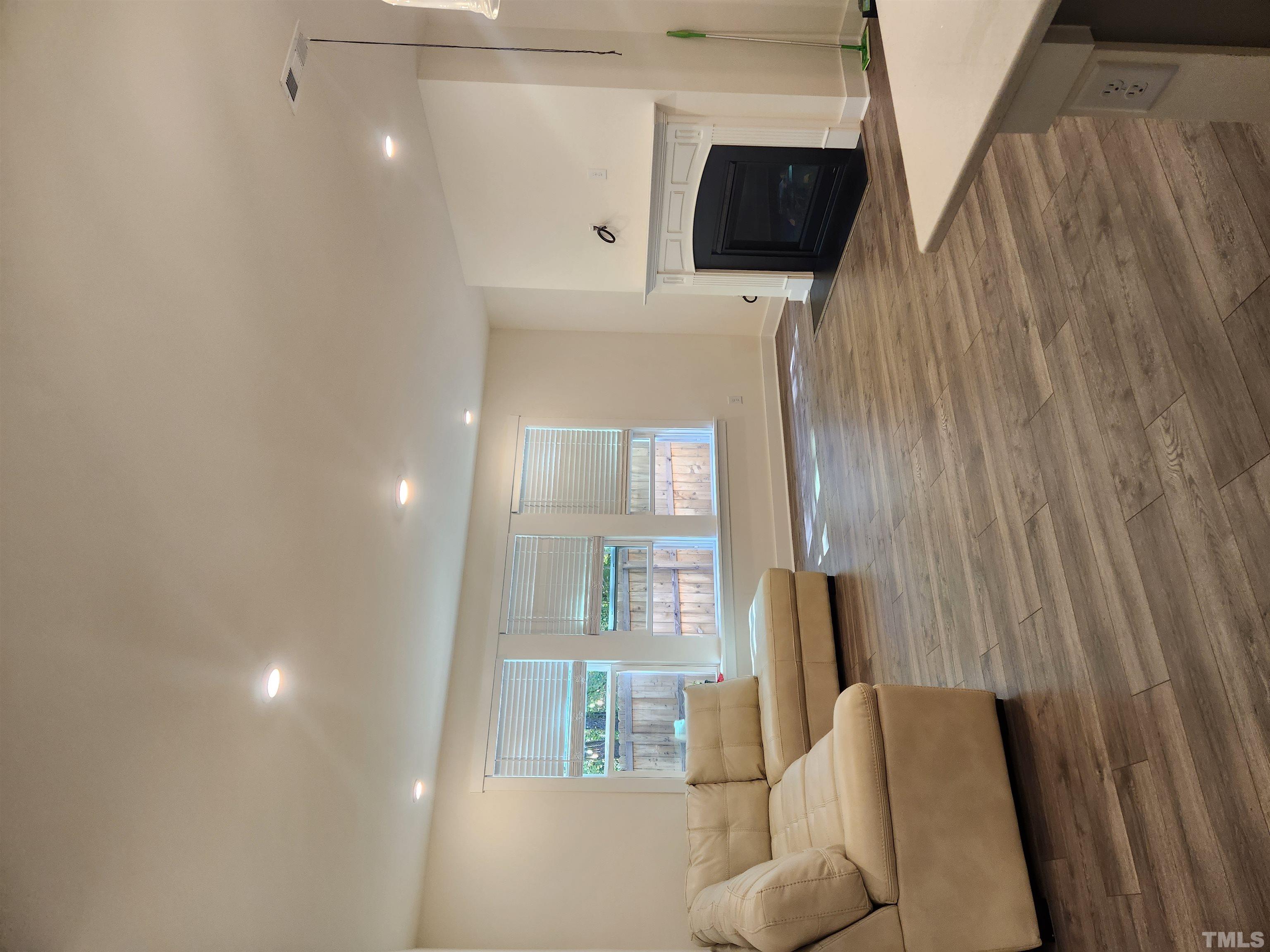 2093 Shaded Knoll Road Cary, NC 27519 - Photo 7 of 9 a living room with furniture and a fireplace