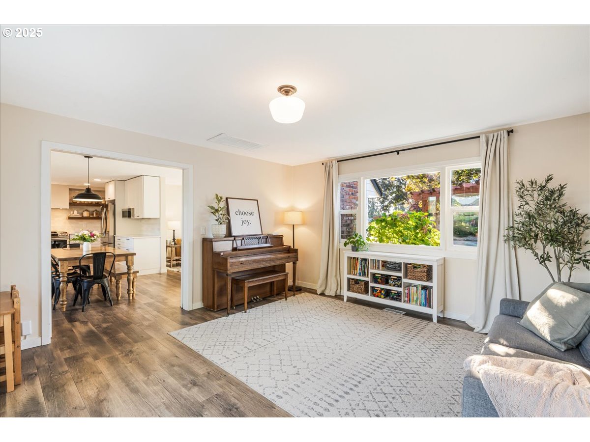 1200 Elm Lane Newberg, OR 97132 - Photo 15 of 32 a living room with furniture a window and a flat screen tv