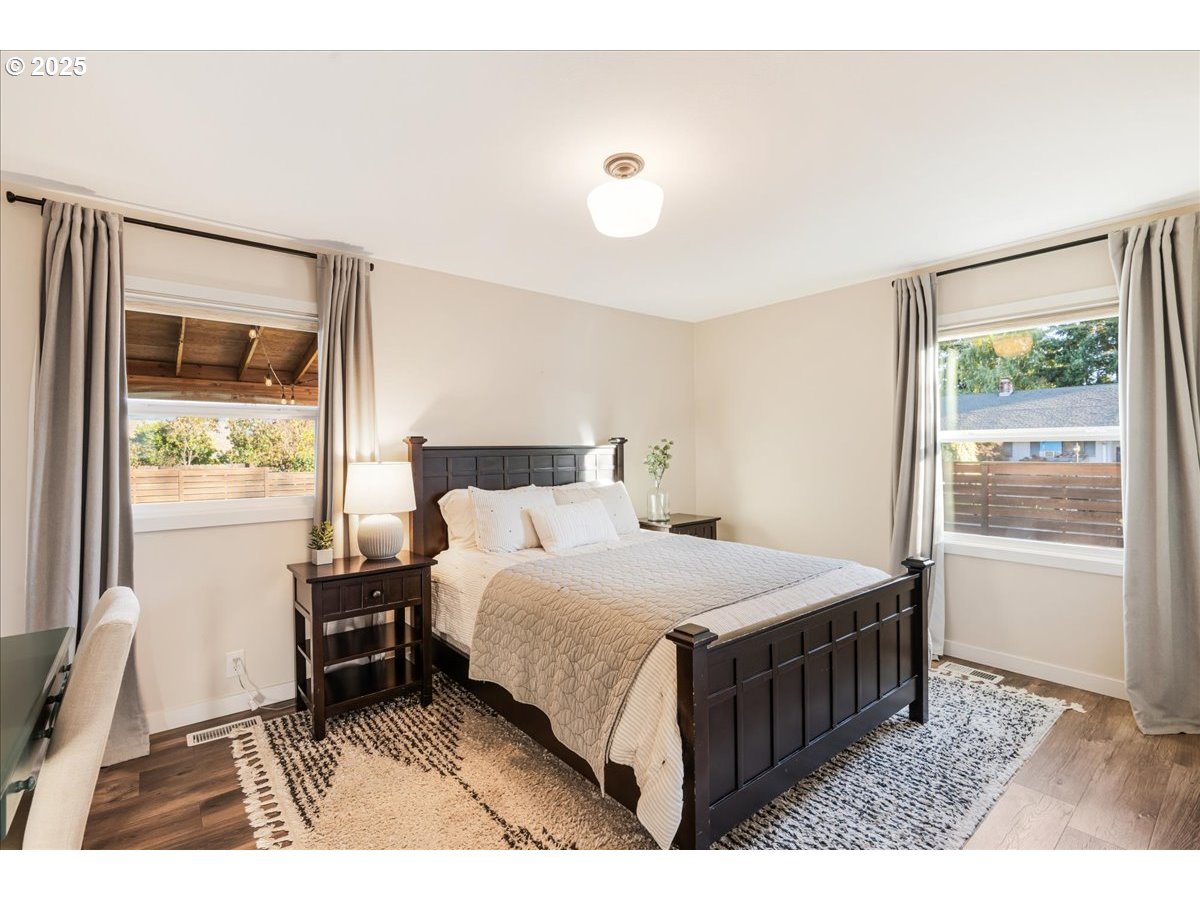 1200 Elm Lane Newberg, OR 97132 - Photo 18 of 32 a bedroom with a bed a window and a flat screen tv