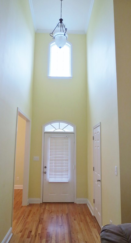 321 Eagle Ridge Road Macon, GA 31216 - Photo 2 of 23 an empty room with wooden floor cabinet and windows
