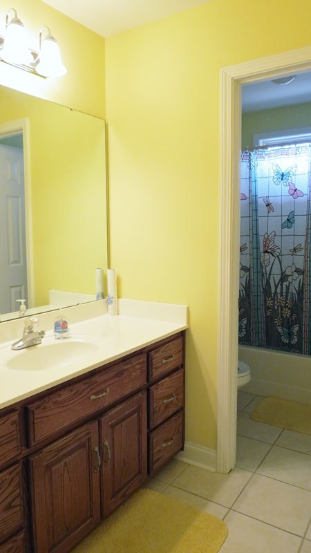 321 Eagle Ridge Road Macon, GA 31216 - Photo 15 of 23 a bathroom with a double vanity sink and a mirror