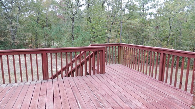 321 Eagle Ridge Road Macon, GA 31216 - Photo 18 of 23 a balcony with wooden floor and trees in the back