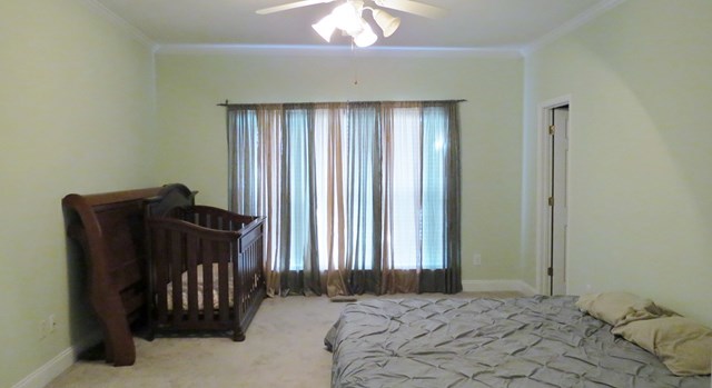 321 Eagle Ridge Road Macon, GA 31216 - Photo 10 of 23 a bedroom with a bed and a chandelier