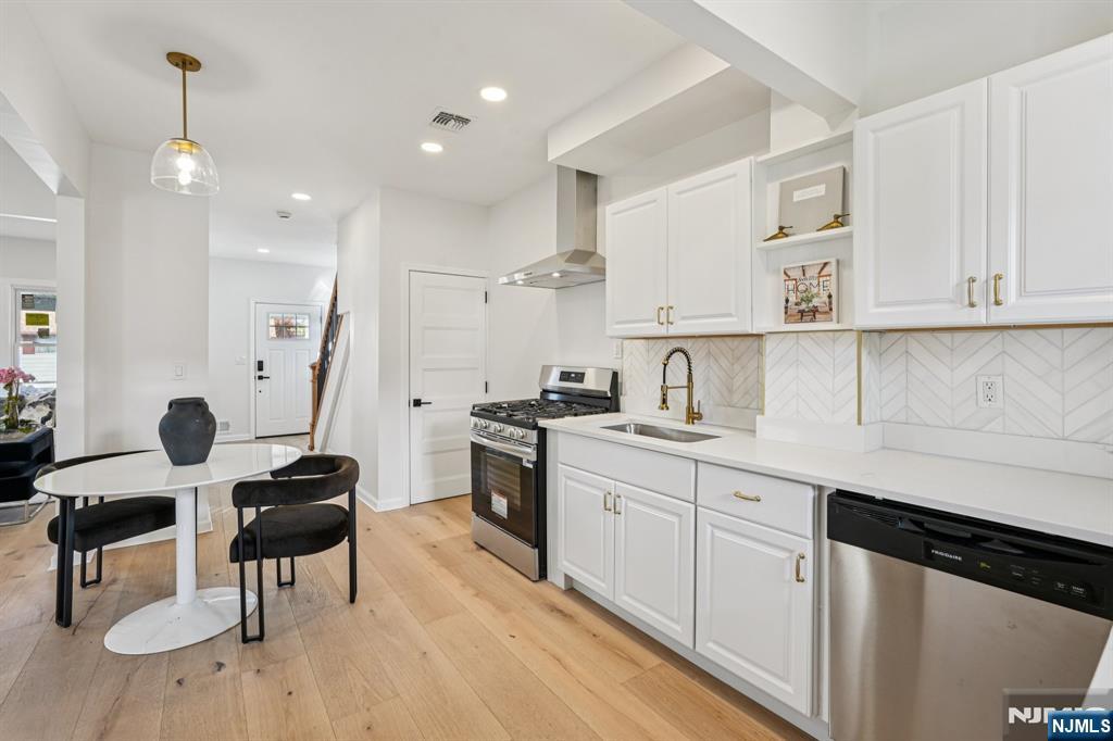 51 Highland Place Ridgefield Park, NJ 07660 - Photo 15 of 35 a kitchen with stainless steel appliances kitchen island granite countertop a sink and cabinets