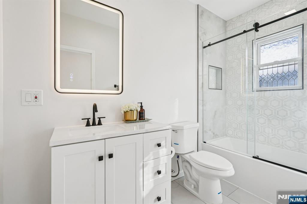 51 Highland Place Ridgefield Park, NJ 07660 - Photo 17 of 35 a bathroom with a sink a toilet and shower