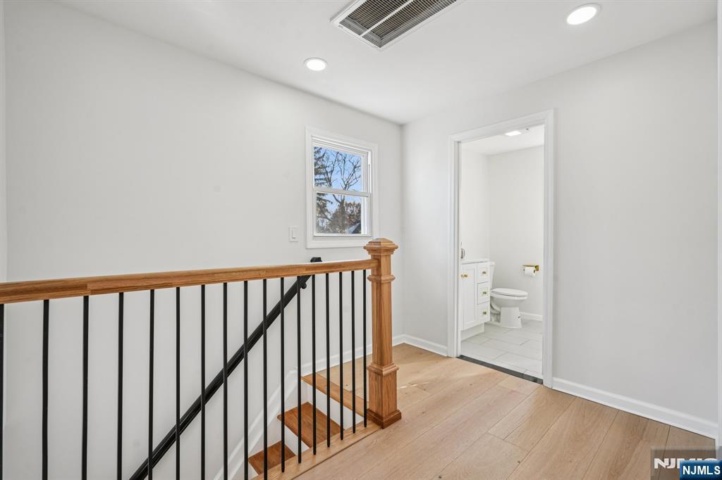 51 Highland Place Ridgefield Park, NJ 07660 - Photo 29 of 35 a view of a hallway with wooden floor and a bathroom