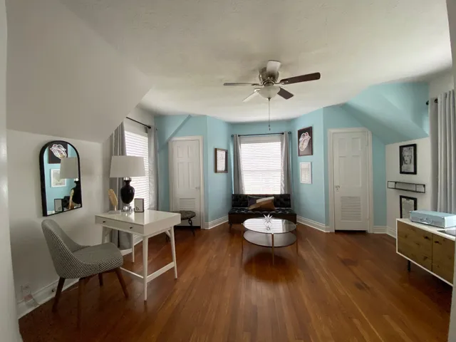 a living room with furniture a window and a chandelier