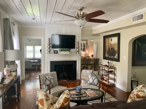 a living room with furniture a flat screen tv and a fireplace