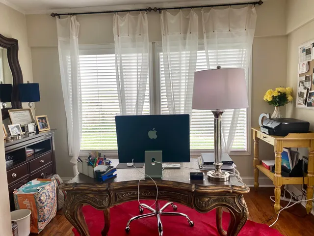 a room with furniture a lamp and a large window