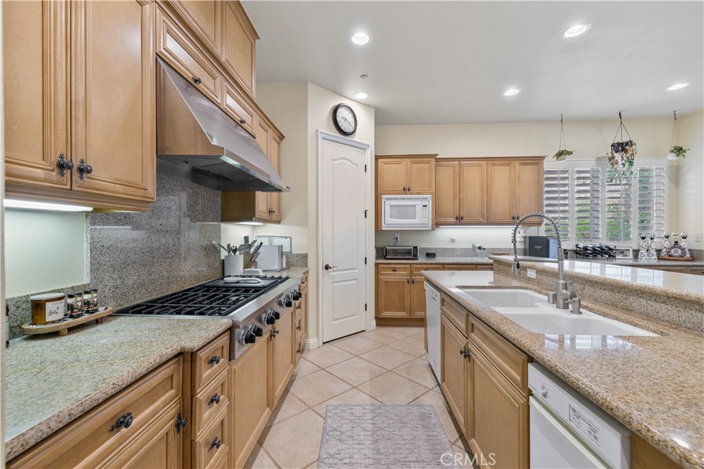 4959 Shady Trail Street Simi Valley, CA 93063 - Photo 13 of 40 a kitchen with stainless steel appliances granite countertop a sink stove and cabinets