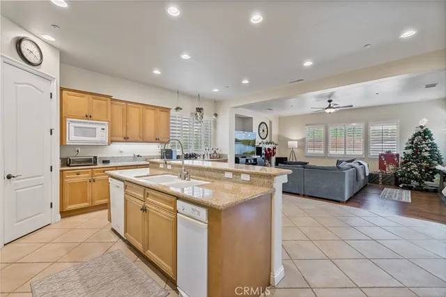 a kitchen with stainless steel appliances granite countertop a sink and cabinets