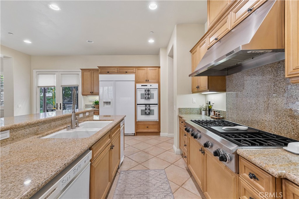 4959 Shady Trail Street Simi Valley, CA 93063 - Photo 15 of 40 a kitchen with granite countertop a sink stove and cabinets