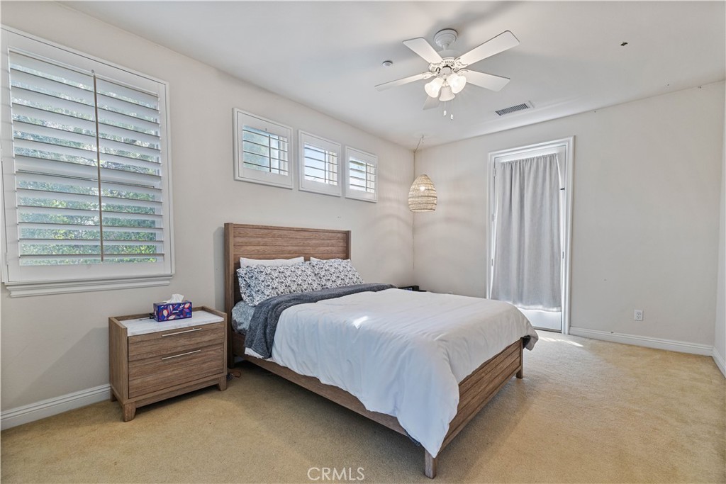 4959 Shady Trail Street Simi Valley, CA 93063 - Photo 26 of 40 a bedroom with a bed and a ceiling fan