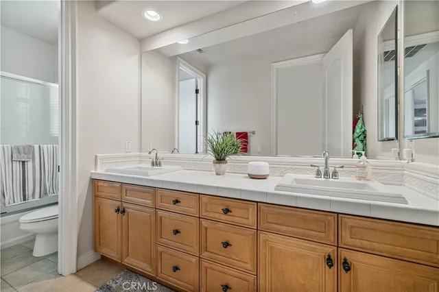 a bathroom with double sink and a toilet