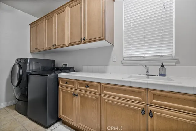 a kitchen with stainless steel appliances granite countertop white cabinets and a sink