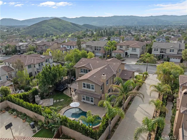 an aerial view of a house with a swimming pool