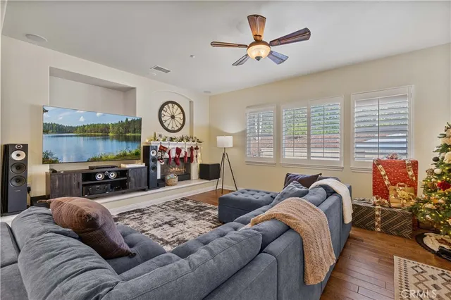 a living room with furniture a large window and a flat screen tv