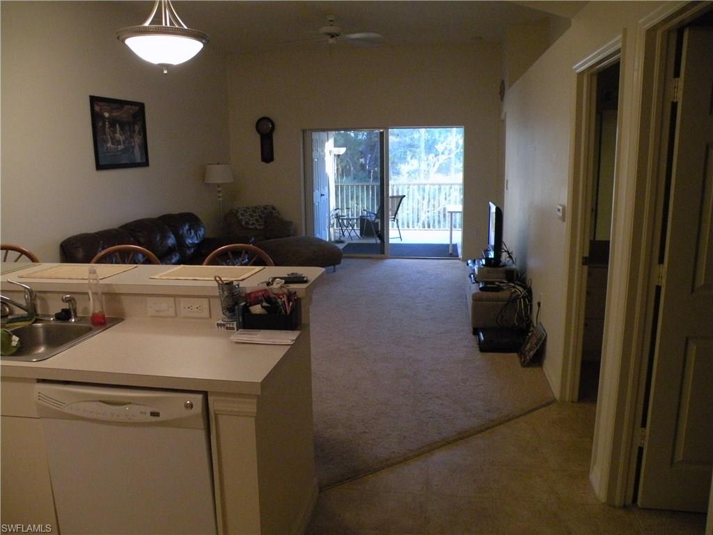 4440 Botanical Pl Circle, Unit 404 Naples, FL 34112 - Photo 3 of 11 a bed room with furniture and a window