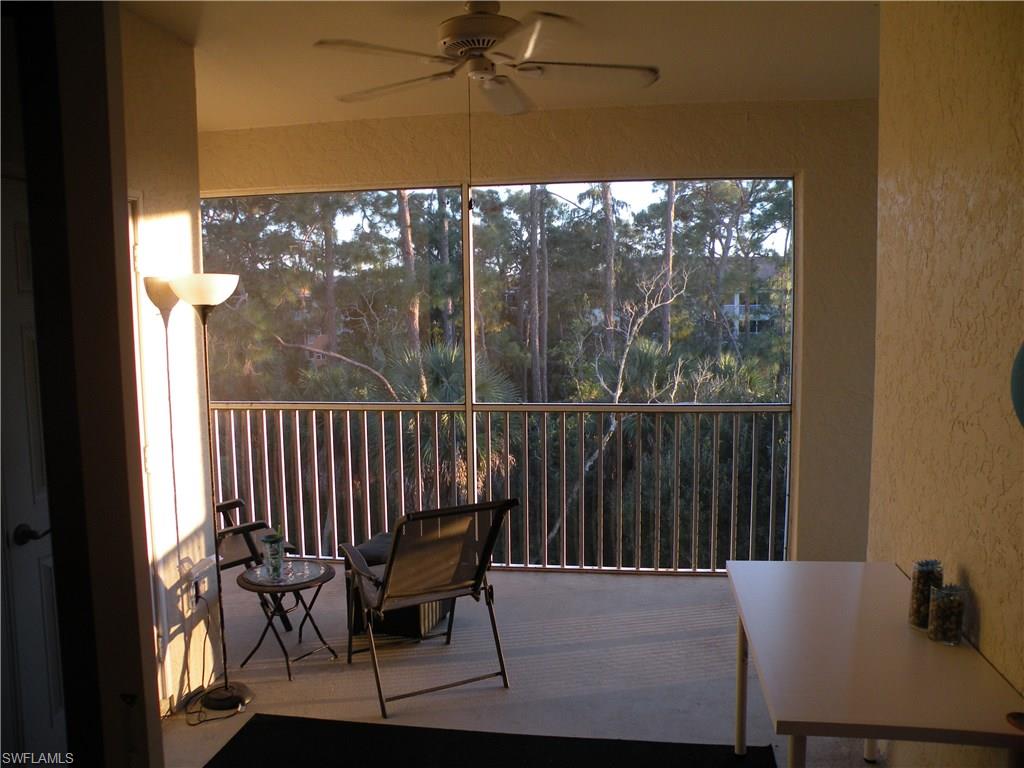 4440 Botanical Pl Circle, Unit 404 Naples, FL 34112 - Photo 6 of 11 a balcony view with a couple of chairs