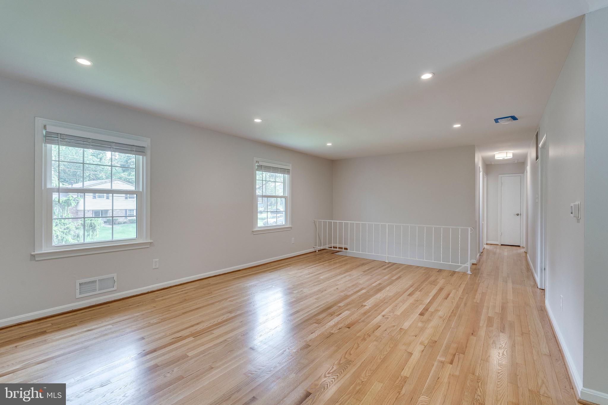 9808 Brixton Lane Bethesda, MD 20817 - Photo 12 of 24 a view of an empty room with wooden floor and a window