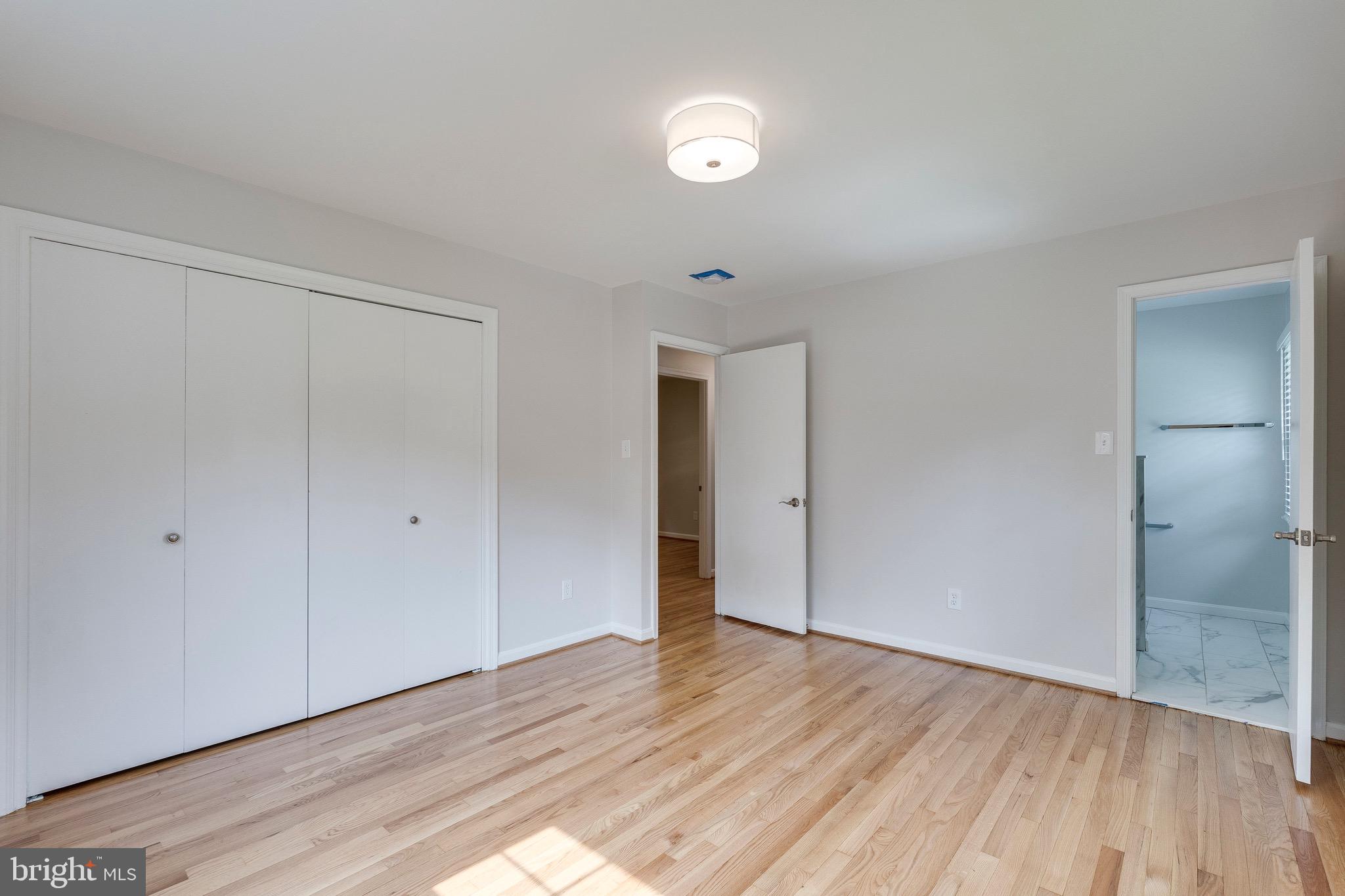 9808 Brixton Lane Bethesda, MD 20817 - Photo 16 of 24 a view of an empty room with wooden floor and closet