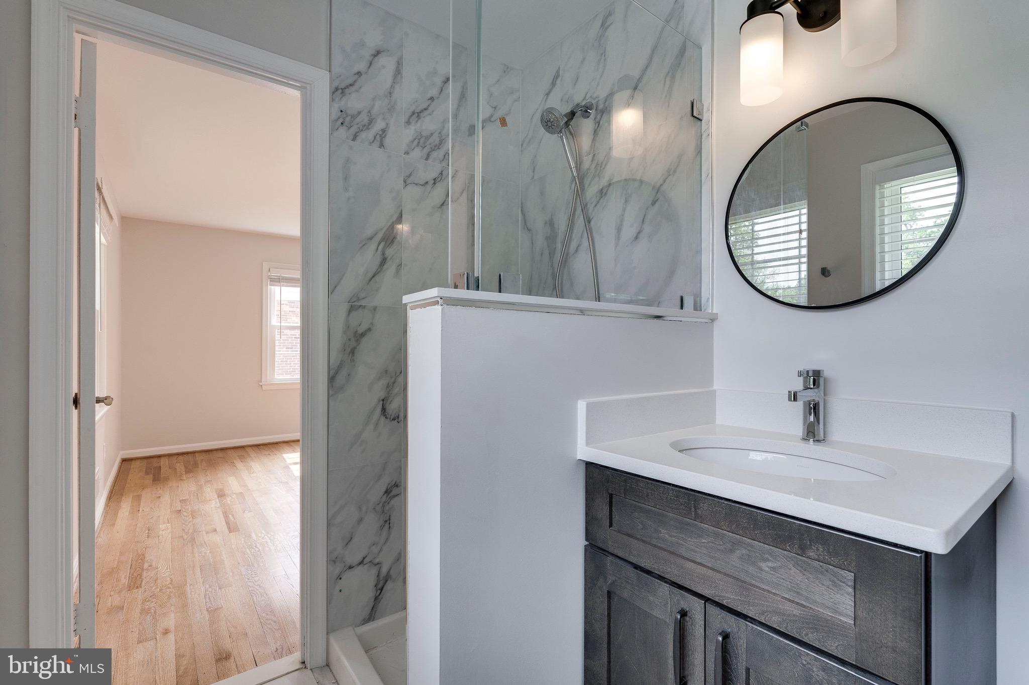 9808 Brixton Lane Bethesda, MD 20817 - Photo 18 of 24 a bathroom with a sink and a mirror