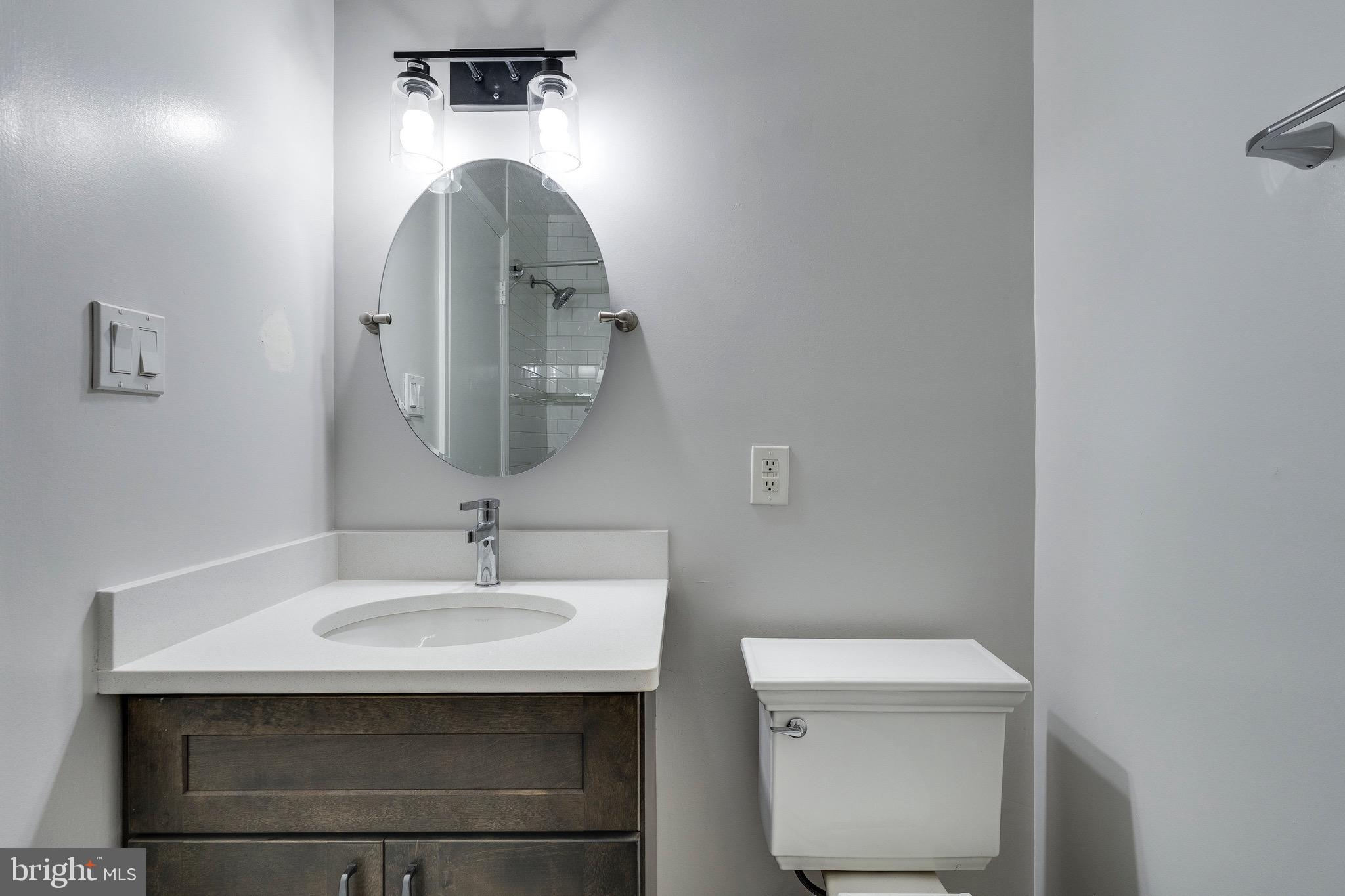 9808 Brixton Lane Bethesda, MD 20817 - Photo 21 of 24 a bathroom with a sink and a mirror