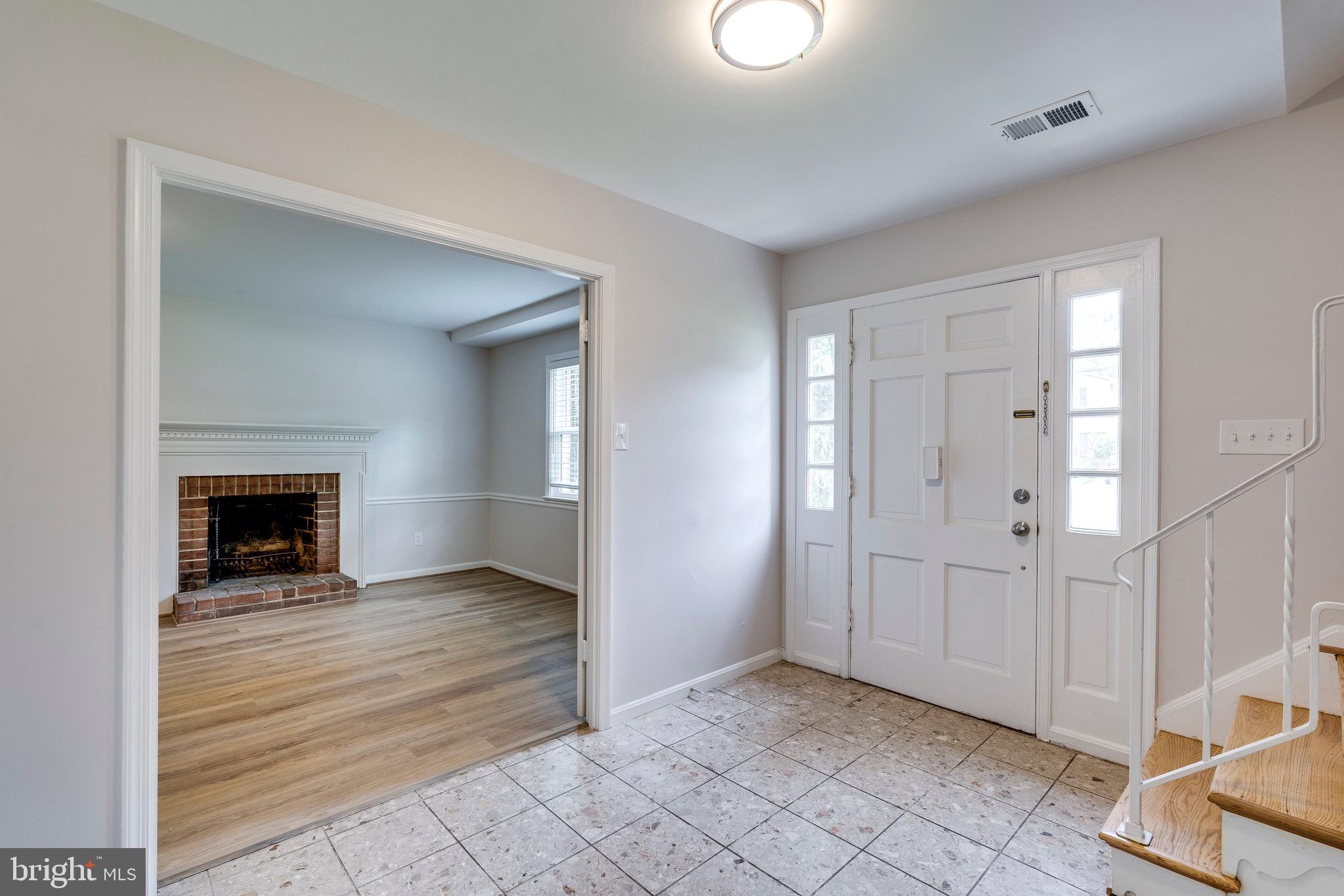 9808 Brixton Lane Bethesda, MD 20817 - Photo 3 of 24 an empty room with fireplace