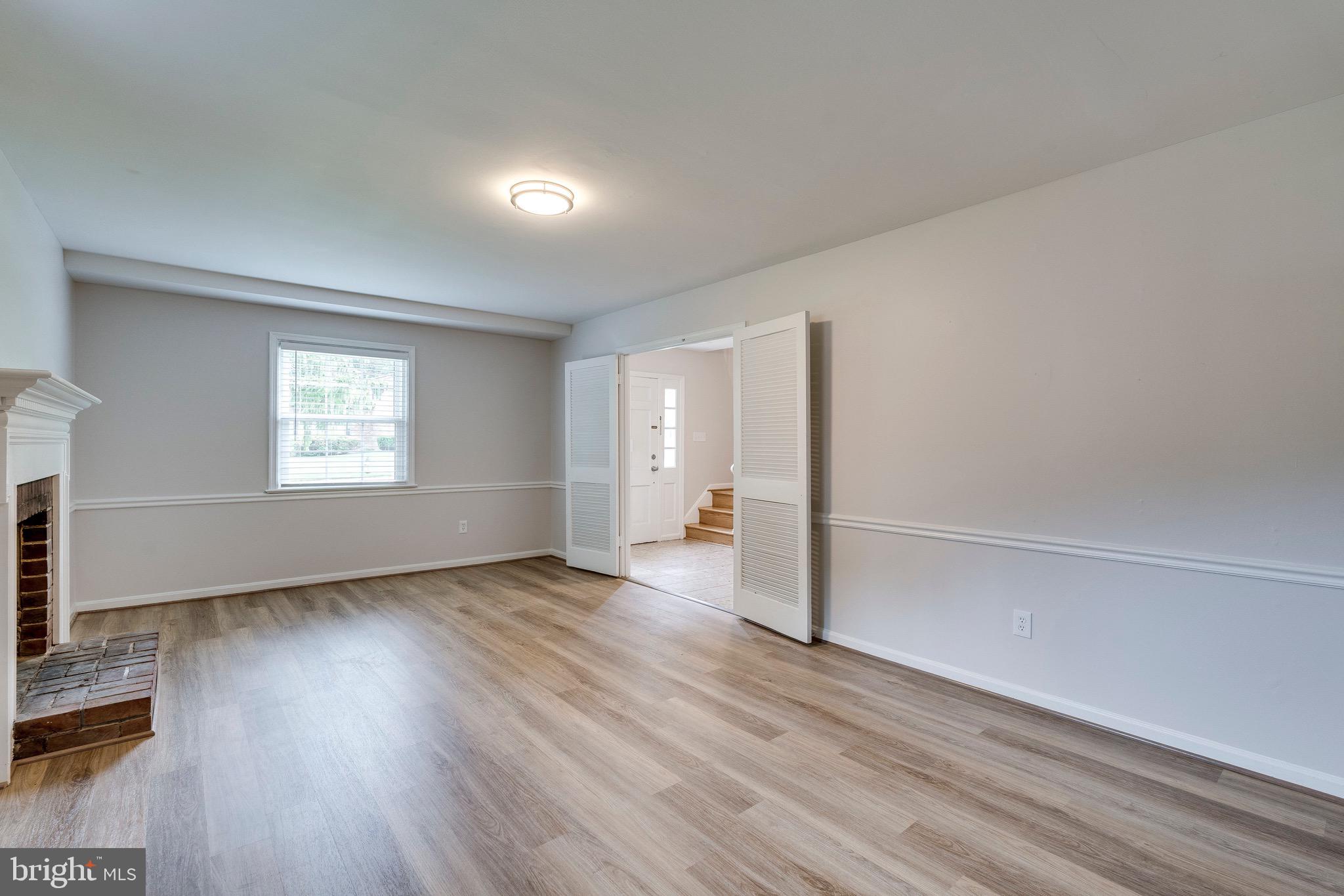 9808 Brixton Lane Bethesda, MD 20817 - Photo 5 of 24 an empty room with wooden floor cabinet and windows