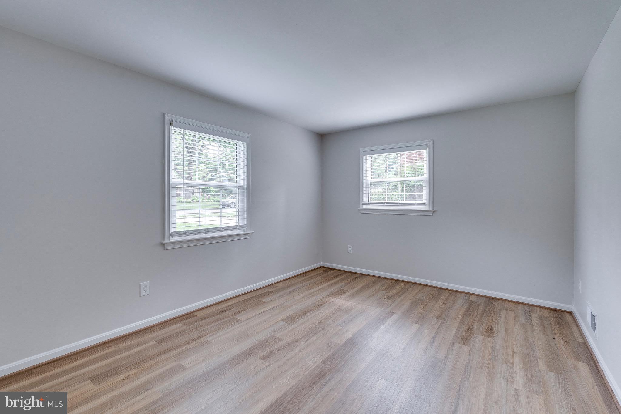 9808 Brixton Lane Bethesda, MD 20817 - Photo 7 of 24 an empty room with wooden floor and windows