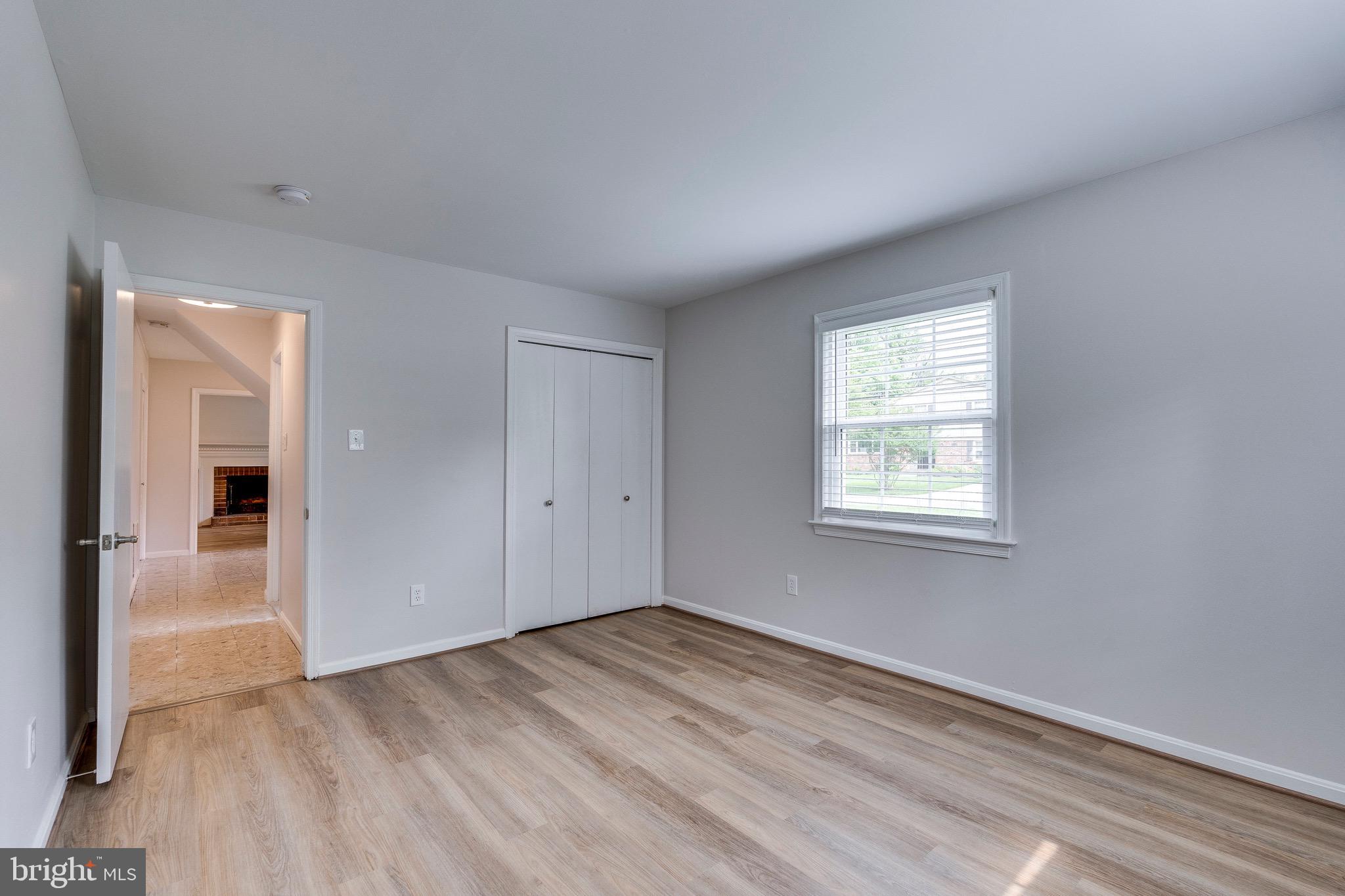 9808 Brixton Lane Bethesda, MD 20817 - Photo 8 of 24 an empty room with wooden floor and windows