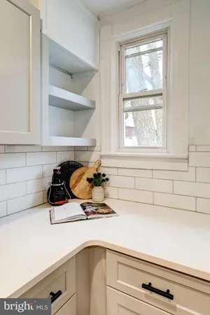 a kitchen with a stove cabinets and a window