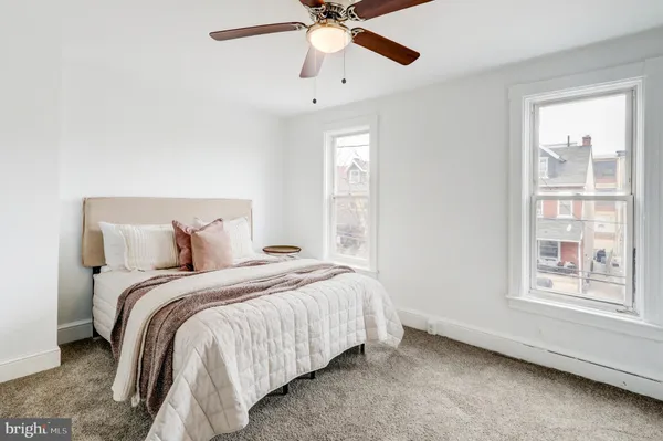 a bedroom with a bed and a chandelier