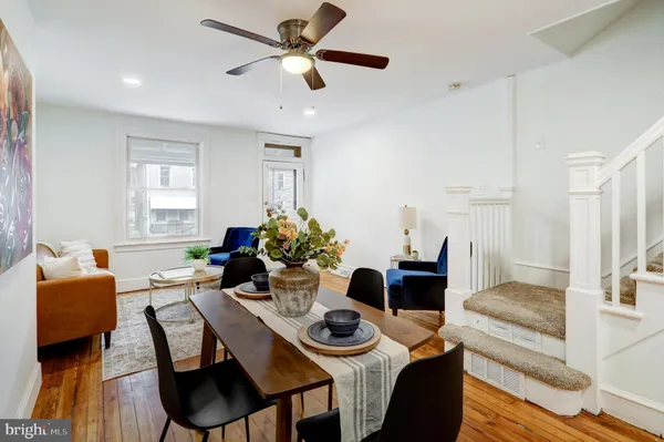 a dining room with furniture and wooden floor