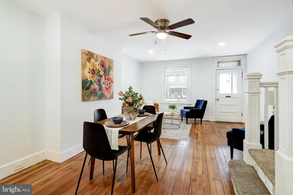 a view of a dining room with furniture and wooden floor
