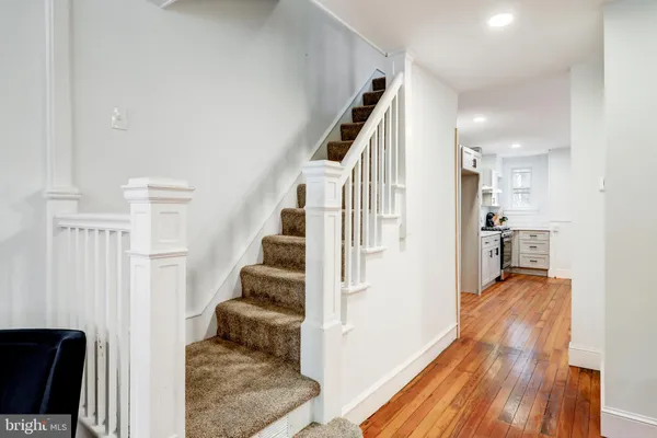 a view of entryway and hall with wooden floor