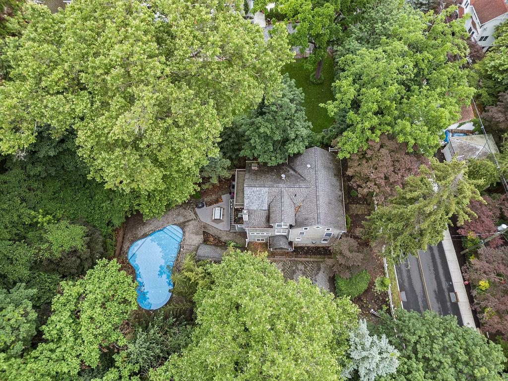 an aerial view of a house with garden space and sitting area