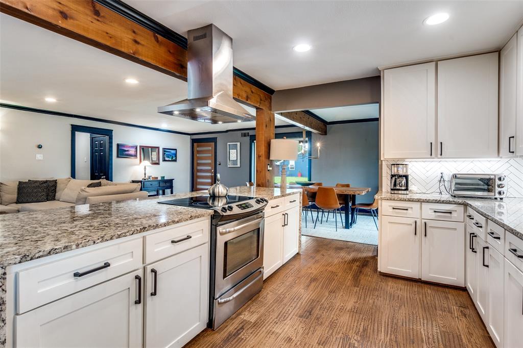 10355 Carry Back Circle Dallas, TX 75229 - Photo 16 of 35 a kitchen with white cabinets and stainless steel appliances