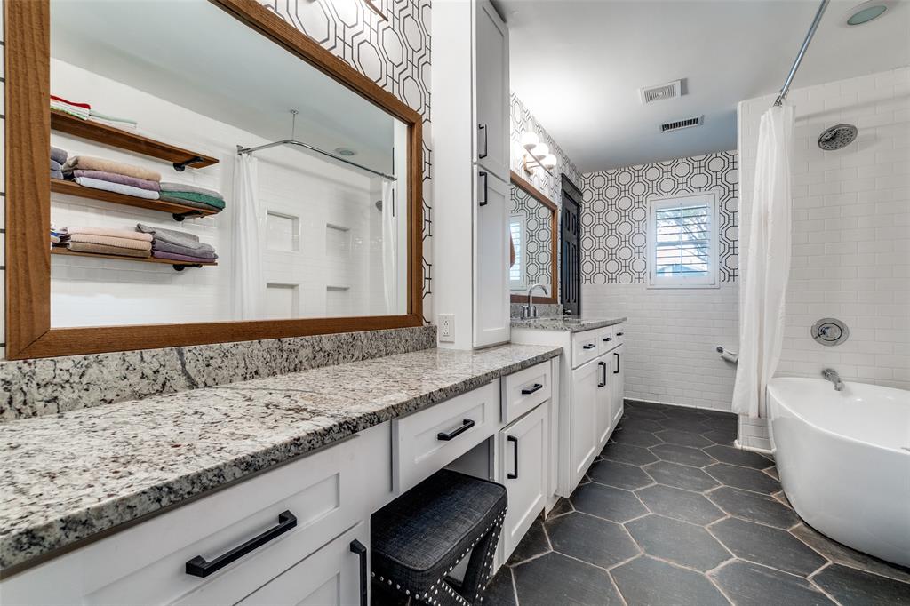 10355 Carry Back Circle Dallas, TX 75229 - Photo 21 of 35 a large bathroom with a granite countertop double vanity sink a mirror and a bathtub