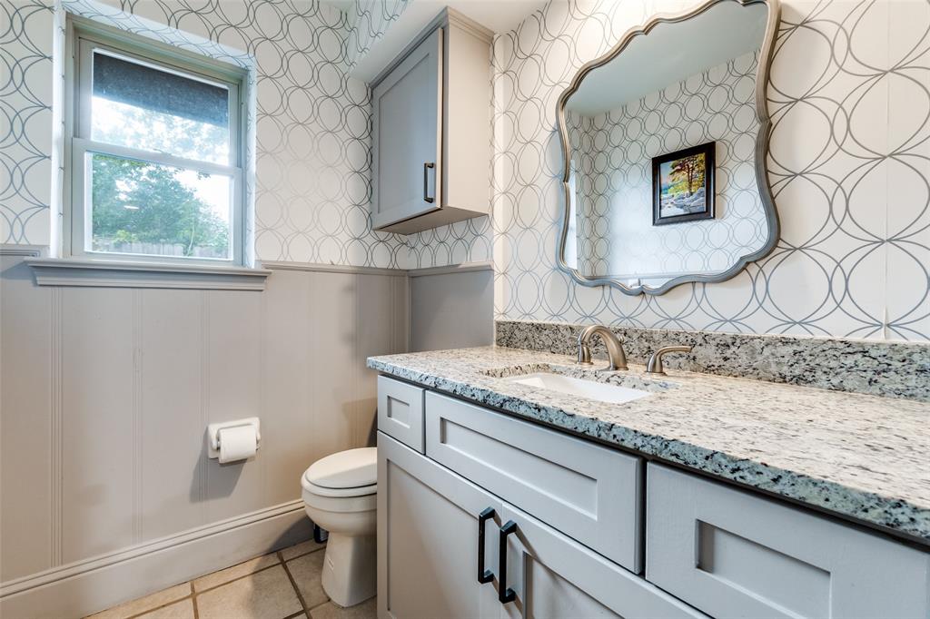 10355 Carry Back Circle Dallas, TX 75229 - Photo 25 of 35 a bathroom with a granite countertop sink and a toilet