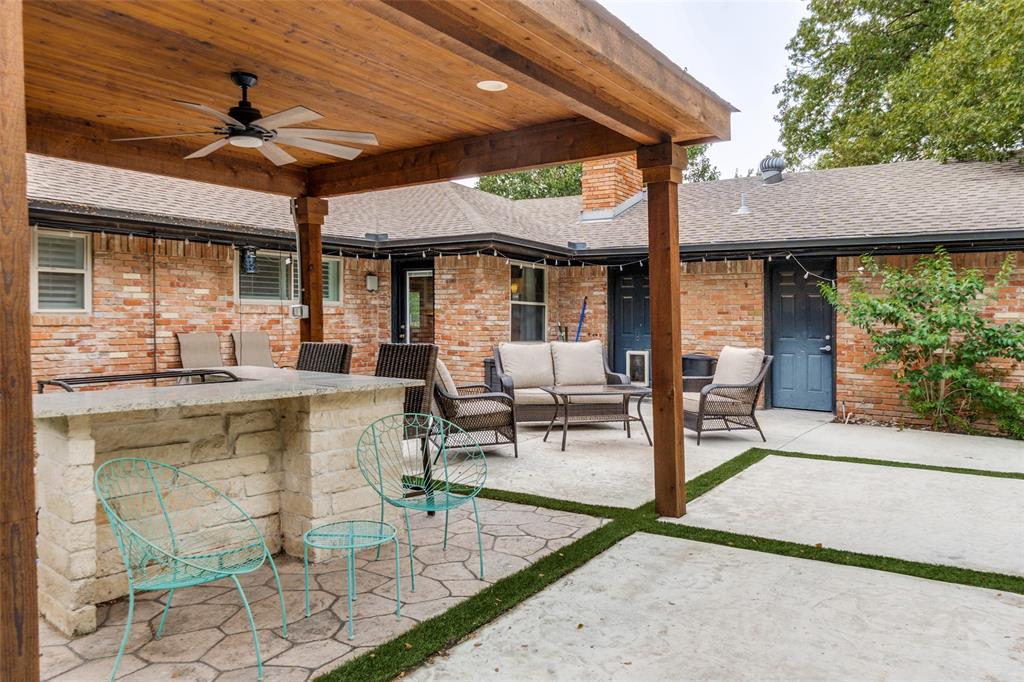 10355 Carry Back Circle Dallas, TX 75229 - Photo 27 of 37 a view of a patio with a table and chairs under an umbrella
