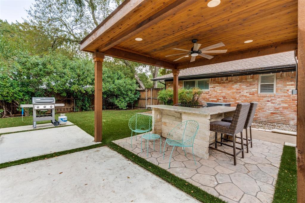 10355 Carry Back Circle Dallas, TX 75229 - Photo 27 of 35 a view of a patio with table and chairs potted plants and a large tree