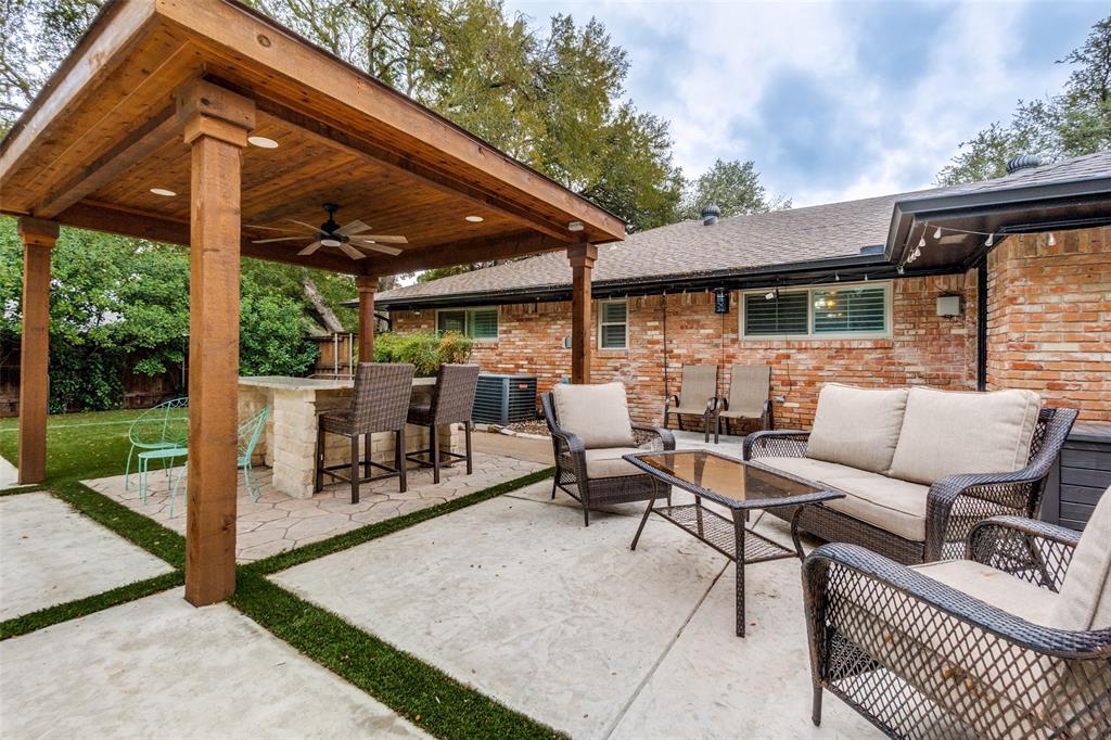 10355 Carry Back Circle Dallas, TX 75229 - Photo 28 of 35 a view of a patio with a table and chairs under an umbrella