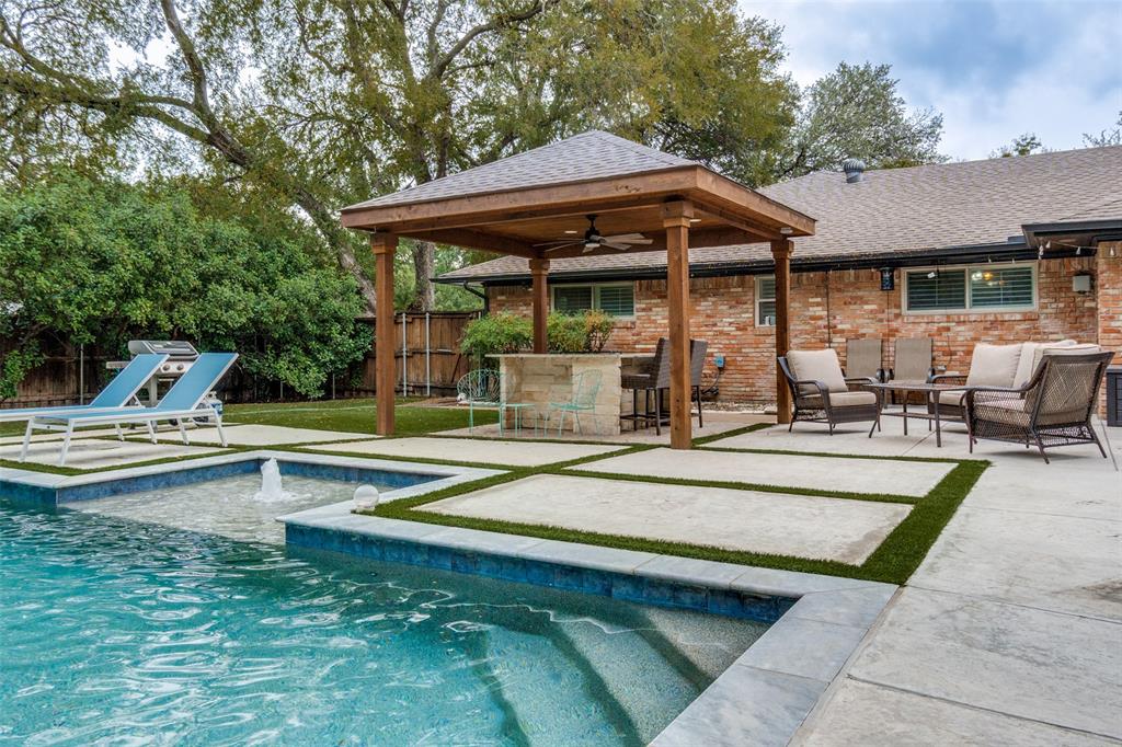 10355 Carry Back Circle Dallas, TX 75229 - Photo 34 of 35 a view of pool with table and chairs under an umbrella